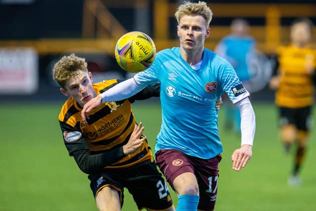 Hearts debutant Gary Mackay-Steven tussles with Alloa's Lucas Williamson.