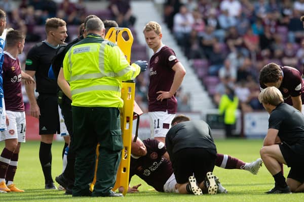 Liam Boyce is treated before being stretchered off in Hearts' 3-2 win over St St Johnstone. (Photo by Ross Parker / SNS Group)
