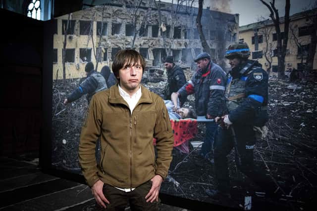 Winner of the 2023 World Press Photo of the Year award, Ukrainian photographer Evgeniy Maloletka, who works for the Associated Press (AP), poses next to his winning photo in the Nieuwe Kerk, in Amsterdam on April 20, 2023. - Maloletka won with this photo that portrays injured pregnant woman Iryna Kalinina, 32, being carried from a maternity
hospital that was damaged during an airstrike on Mariupol. Russian forces invaded Ukraine on 24 February 2022. (Photo by Ramon van Flymen / ANP / AFP) / Netherlands OUT (Photo by RAMON VAN FLYMEN/ANP/AFP via Getty Images)