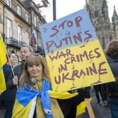 A protest against Vladimir Putin's invasion of Ukraine outside the Russian consulate in Edinburgh. The Russian flag can be seen in the background (Picture: Lesley Martin/PA)