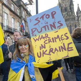 A protest against Vladimir Putin's invasion of Ukraine outside the Russian consulate in Edinburgh. The Russian flag can be seen in the background (Picture: Lesley Martin/PA)