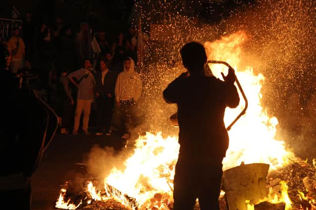 Protesters block a road as they gather around a bonfire during a rally against the Israeli government's judicial reform in Tel Aviv, Israel.