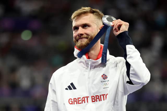 Silver medallist Josh Kerr of Great Britain celebrates on the podium during the men's 1500m medal ceremony on day eleven of the Olympic Games Paris 2024 at Stade de France. (Photo by Hannah Peters/Getty Images)