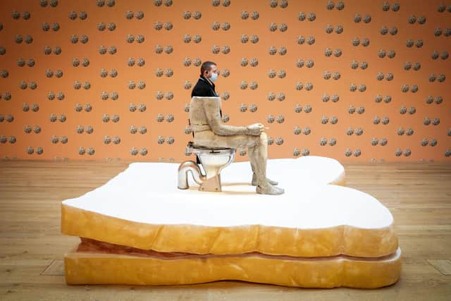 V&A Dundee security guard Darren Rout stands alongside artist Sarah Lucas's cast of dance and choreographer Michael Clark's body. Picture: Jane Barlow/PA Wire