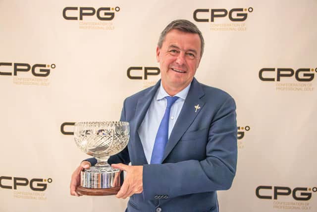 Edward Kitson shows off the Confederation of Professional Golf's Christer Lindberg Bowl.