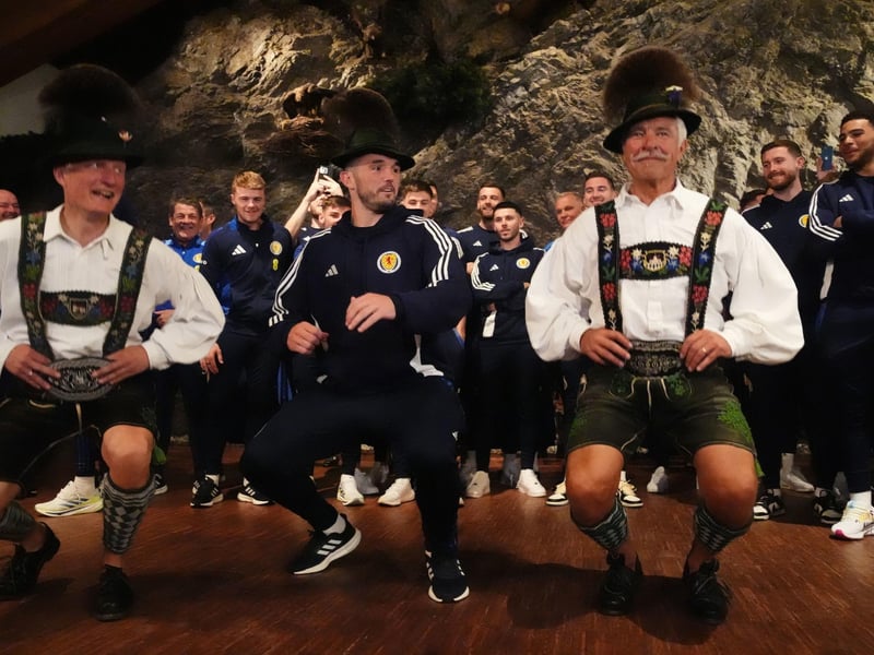 Scotland's John McGinn (centre) joins in with a dance as the team arrive at Bayernhalle in Garmisch-Partenkirchen, Germany, for a reception hosted by the Mayor.