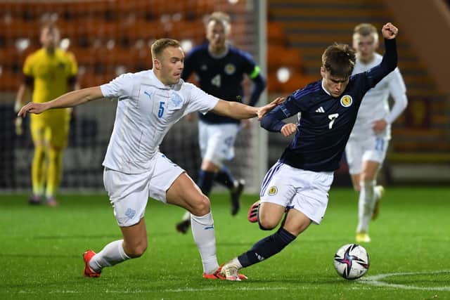 Scotland's Ben Doak tries to get away from Iceland's Olafur Gudmundsson during the Under-21 friendly at Fir Park.  (Photo by Ross MacDonald / SNS Group)