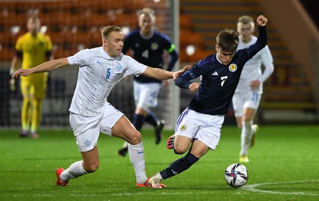 Scotland's Ben Doak tries to get away from Iceland's Olafur Gudmundsson during the Under-21 friendly at Fir Park.  (Photo by Ross MacDonald / SNS Group)