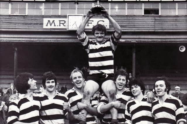 More success for Kelso at the Melrose Sevens as captain Eric Paxton lifts the trophy with Bob Hogarth, Euan Common, Jim Hewitt, Gary Callander, Roger Baird and Andrew Ker. Picture: Hamish Campbell