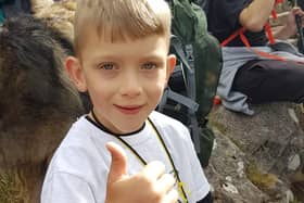Caeden Thomson, a seven-year-old with cerebral palsy, during his climb to the summit of Ben Nevis for charity on Saturday.