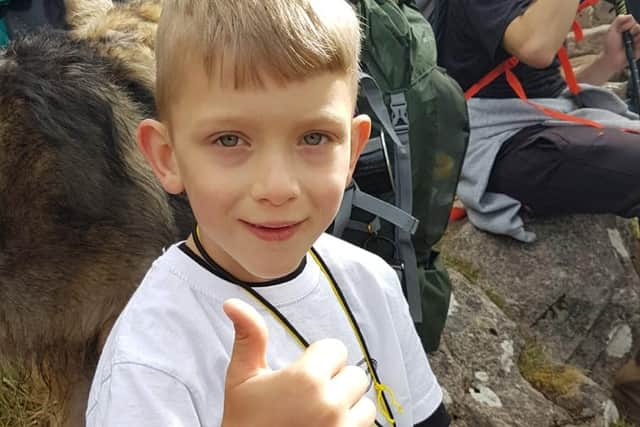 Caeden Thomson, a seven-year-old with cerebral palsy, during his climb to the summit of Ben Nevis for charity on Saturday.