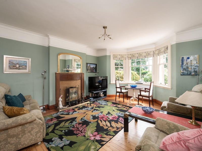 Interior: The lounge and dining room both feature bay windows, with two bedrooms on the ground floor and another two upstairs. Sliding doors in the sunroom open to a terrace and there is a cellar and greenhouse set into the lower ground floor.