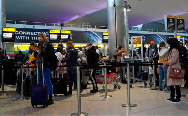 Customers at a TAP Air Portugal check-in desk in the departures hall at Terminal 2 of Heathrow Airport on December 21, 2020. Picture: NIKLAS HALLE'N/AFP via Getty Images