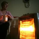 An old age pensioner keeps warm with the aid of an electric heater - far fewer pensioners will be eligible for the winter fuel payment this year  (Photo by Christopher Furlong/Getty Images)