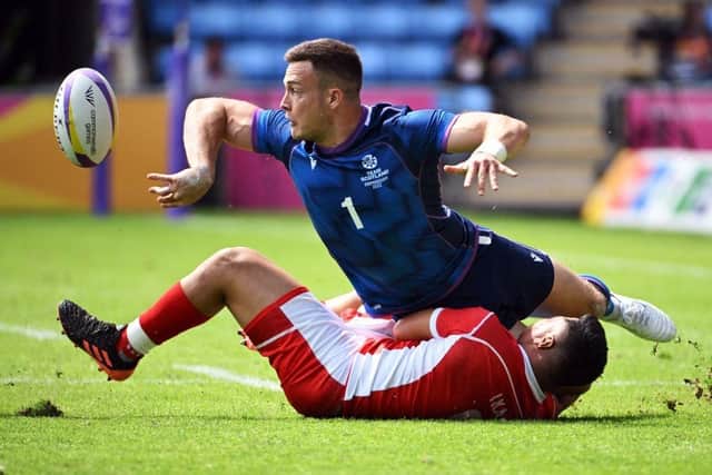 Scotland's Jordan Edmunds is tackled by Tonga's John Ika during the Men's Pool B rugby sevens match between Scotland and Tonga on day one of the Commonwealth Games at the Coventry Arena.
