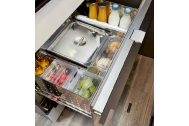 A space-saving drawer fridge has plenty of space for a few cold drinks to enjoy of an evening.