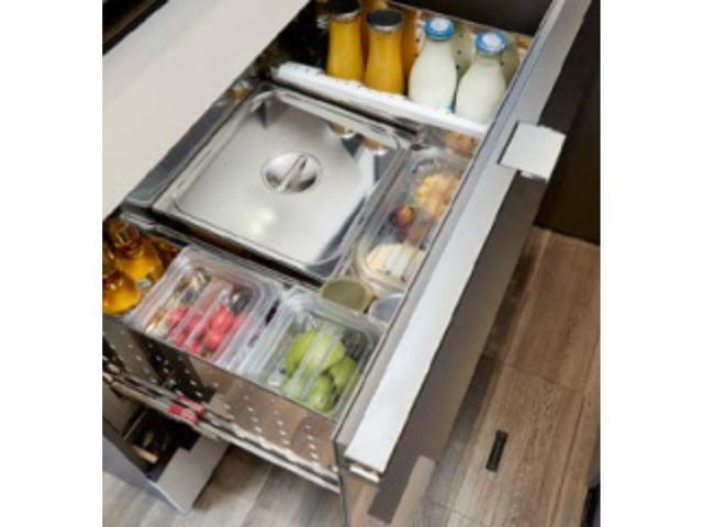 A space-saving drawer fridge has plenty of space for a few cold drinks to enjoy of an evening.