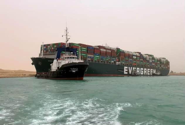 The MV Ever Given cargo ship ended up stuck sideways in the Suez Canal, after a gust of wind blew it off course, impeding traffic through one of the world's busiest trade routes (Picture: Suez Canal/AFP via Getty Images)