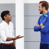 Britain's Prime Minister Rishi Sunak (L) talks with England striker Harry Kane back in October.