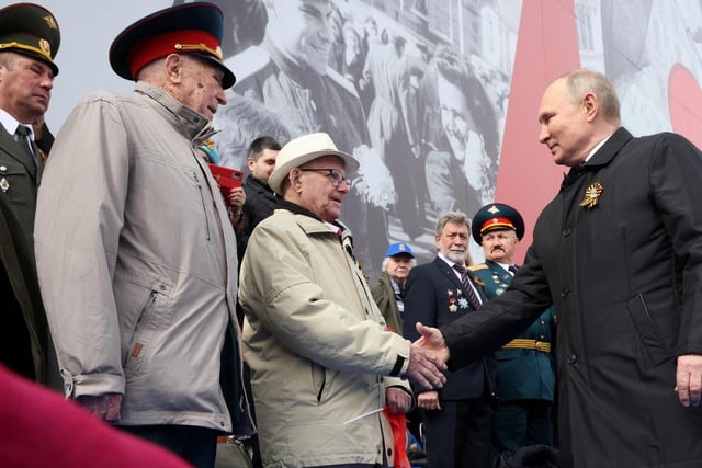 Russian President Vladimir Putin greets veterans as he arrives to watch the Victory Day military parade at Red Square in central Moscow on May 9, 2022. Mikhail Metzel via Getty Images)