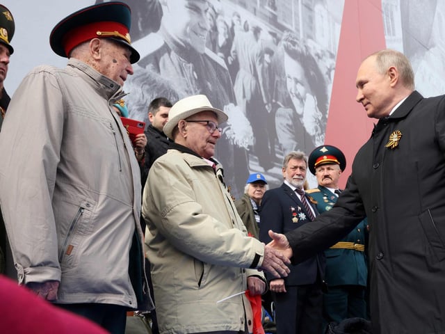 Russian President Vladimir Putin greets veterans as he arrives to watch the Victory Day military parade at Red Square in central Moscow on May 9, 2022. Mikhail Metzel via Getty Images)