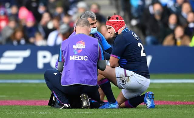 George Turner receives treatment for the rib injury that forced the Scotland hooker off against Australia. (Photo by Paul Devlin / SNS Group)