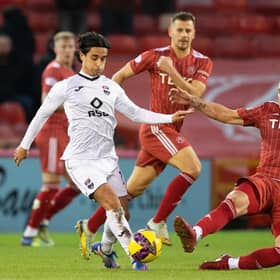 Aberdeen forward Christian Ramirez tries to close down Ross County's Yan Dhanda during the 0-0 draw at Pittodrie.