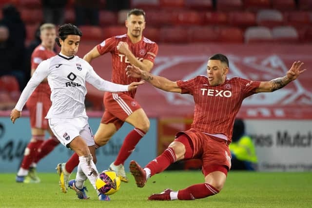 Aberdeen forward Christian Ramirez tries to close down Ross County's Yan Dhanda during the 0-0 draw at Pittodrie.