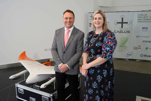 AGS Airports chief executive Derek Provan and CAELUS project director Fiona Smith with one of the drones. Picture: AGS Airports/John Linton