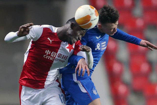 Slavia Prague's Senegalese forward Abdallah Sima (L) and Rangers' Scottish defender Nathan Patterson vie for the ball during the UEFA Europa League, last 16, first Leg football match Slavia Prague v Rangers at the Eden Arena stadium in Prague, Czech Republic, on March 11, 2021. (Photo by Milan Kammermayer / AFP) (Photo by MILAN KAMMERMAYER/AFP via Getty Images)