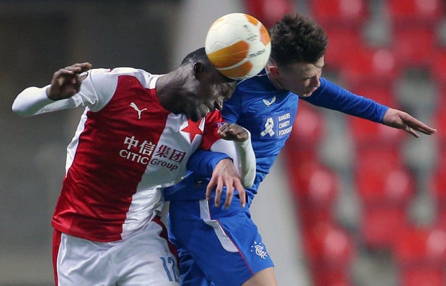 Slavia Prague's Senegalese forward Abdallah Sima (L) and Rangers' Scottish defender Nathan Patterson vie for the ball during the UEFA Europa League, last 16, first Leg football match Slavia Prague v Rangers at the Eden Arena stadium in Prague, Czech Republic, on March 11, 2021. (Photo by Milan Kammermayer / AFP) (Photo by MILAN KAMMERMAYER/AFP via Getty Images)