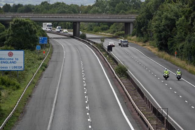 Police escort vehicles along the M4 motorway during the morning rush hour as drivers hold a go-slow protest in a demonstration over high fuel prices