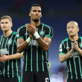 Moritz Jenz and the rest of the Celtic players applaud the travelling fans at the end of the 5-1 defeat to Real Madrid in the Bernabeu. (Photo by THOMAS COEX/AFP via Getty Images)