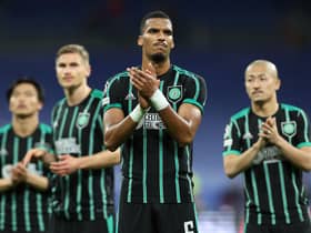 Moritz Jenz and the rest of the Celtic players applaud the travelling fans at the end of the 5-1 defeat to Real Madrid in the Bernabeu. (Photo by THOMAS COEX/AFP via Getty Images)