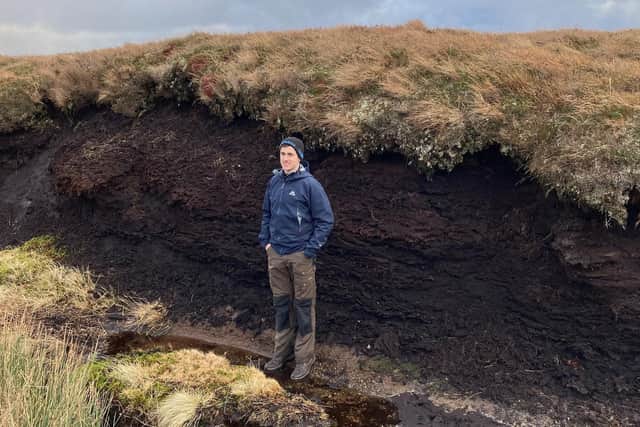 Peatland restoration is one of the emerging carbon markets, according to property consultancy Bidwells -- Matt Hay, from the firm's natural capital and sustainable investment team inspects a peat hagg in the Scottish Highlands that has formed over more than 2,000 years, locking up carbon