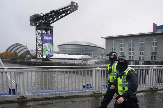 Police officers walk pass the Scottish Event Campus in Glasgow where COP26 is being held. Picture: PA