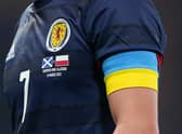 Scotland's John McGinn wears an armband with the Ukrainian colours during the international friendly against Poland in March (Picture: Andrew Milligan/PA)