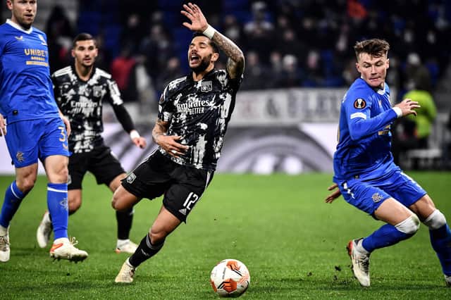Rangers' Nathan Patterson (right) in the thick of the action during the Europa League Group A match against Lyon in France on Thursday.  (Photo by JEFF PACHOUD/AFP via Getty Images)