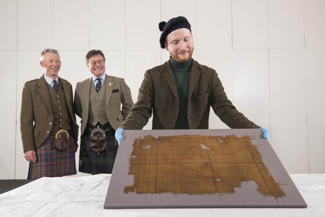 Tartan historian Peter MacDonald and John McLeish, chair of the Scottish Tartans authority with V&A Dundee curator James Wylie and the Glen Affric tartan. Picture: Alan Richardson