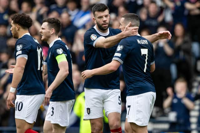 John McGinn is congratulated by his team-mates after opening the scoring at Hampden Park. Picture: SNS