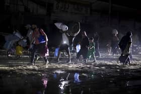 Palestinians displaced by the Israeli air and ground offensive on the Gaza Strip flee from parts of Khan Younis following an evacuation order by the Israeli army (Picture: AP Photo/Jehad Alshrafi)