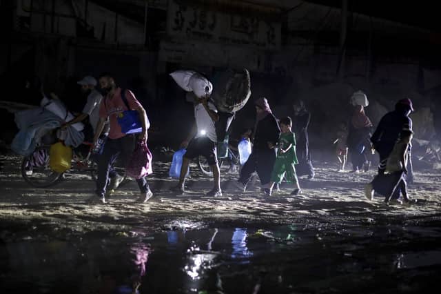 Palestinians displaced by the Israeli air and ground offensive on the Gaza Strip flee from parts of Khan Younis following an evacuation order by the Israeli army (Picture: AP Photo/Jehad Alshrafi)