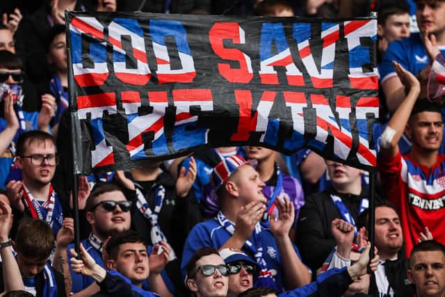 Rangers fans hold a banner which reads 'God Save the King' during the match against Aberdeen at Ibrox.