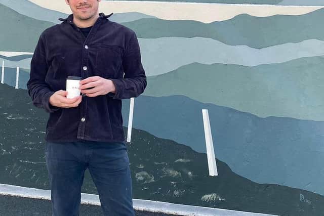 Niall Munro, son of Donnie, with the mural which overlooks his coffee shop Birch in Portree. PIC: Contributed.