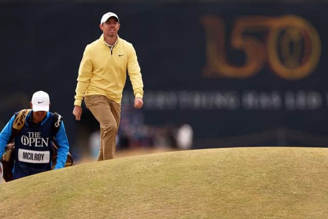 Rory McIlroy and his caddie Harry Diamond walk on the second hole during day one of The 150th Open at St Andrews. Picture: Harry How/Getty Images.