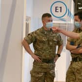 Military personel gesture at a temporary Covid-19 vaccination centre set up at the Royal Highland Showground near Edinburgh, Scotland, on February 4, 2021. Photo by Andrew Milligan via Getty Images