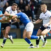 Scotland's Ollie Smith (centre) is challenged during The Famous Grouse Nations Series match between Scotland and Italy at the Scottish Gas Murrayfield Stadium, on July 29, 2023, in Edinburgh, Scotland.  (Photo by Ross Parker / SNS Group)