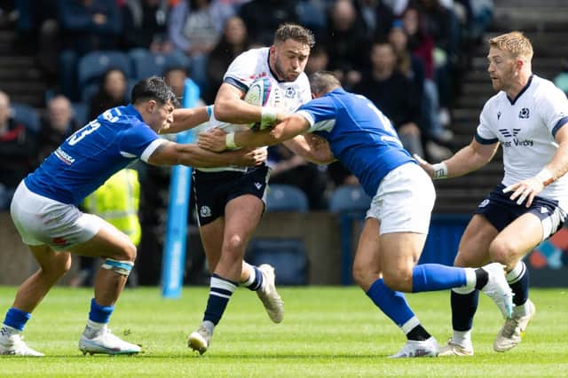 Scotland's Ollie Smith (centre) is challenged during The Famous Grouse Nations Series match between Scotland and Italy at the Scottish Gas Murrayfield Stadium, on July 29, 2023, in Edinburgh, Scotland. (Photo by Ross Parker / SNS Group)