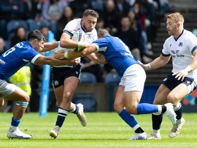 Scotland's Ollie Smith (centre) is challenged during The Famous Grouse Nations Series match between Scotland and Italy at the Scottish Gas Murrayfield Stadium, on July 29, 2023, in Edinburgh, Scotland.  (Photo by Ross Parker / SNS Group)