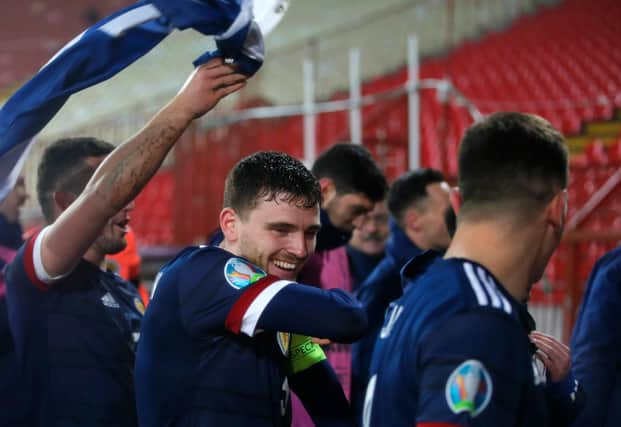 BELGRADE, SERBIA - NOVEMBER 12: Andy Robertson of Scotland celebrates with his team after his teams victory in the UEFA EURO 2020 Play-Off Final between Serbia and Scotland at Rajko Mitic Stadium on November 12, 2020 in Belgrade, Serbia. Football Stadiums around Europe remain empty due to the Coronavirus Pandemic as Government social distancing laws prohibit fans inside venues resulting in fixtures being played behind closed doors. (Photo by Srdjan Stevanovic/Getty Images)